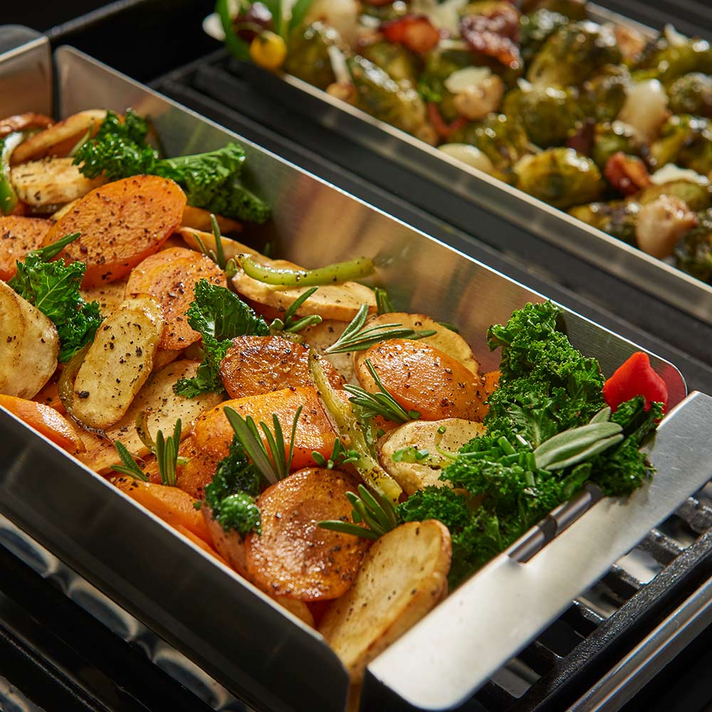 Stainless steel narrow wok topper holding chicken, potatoes, broccoli, and herbs