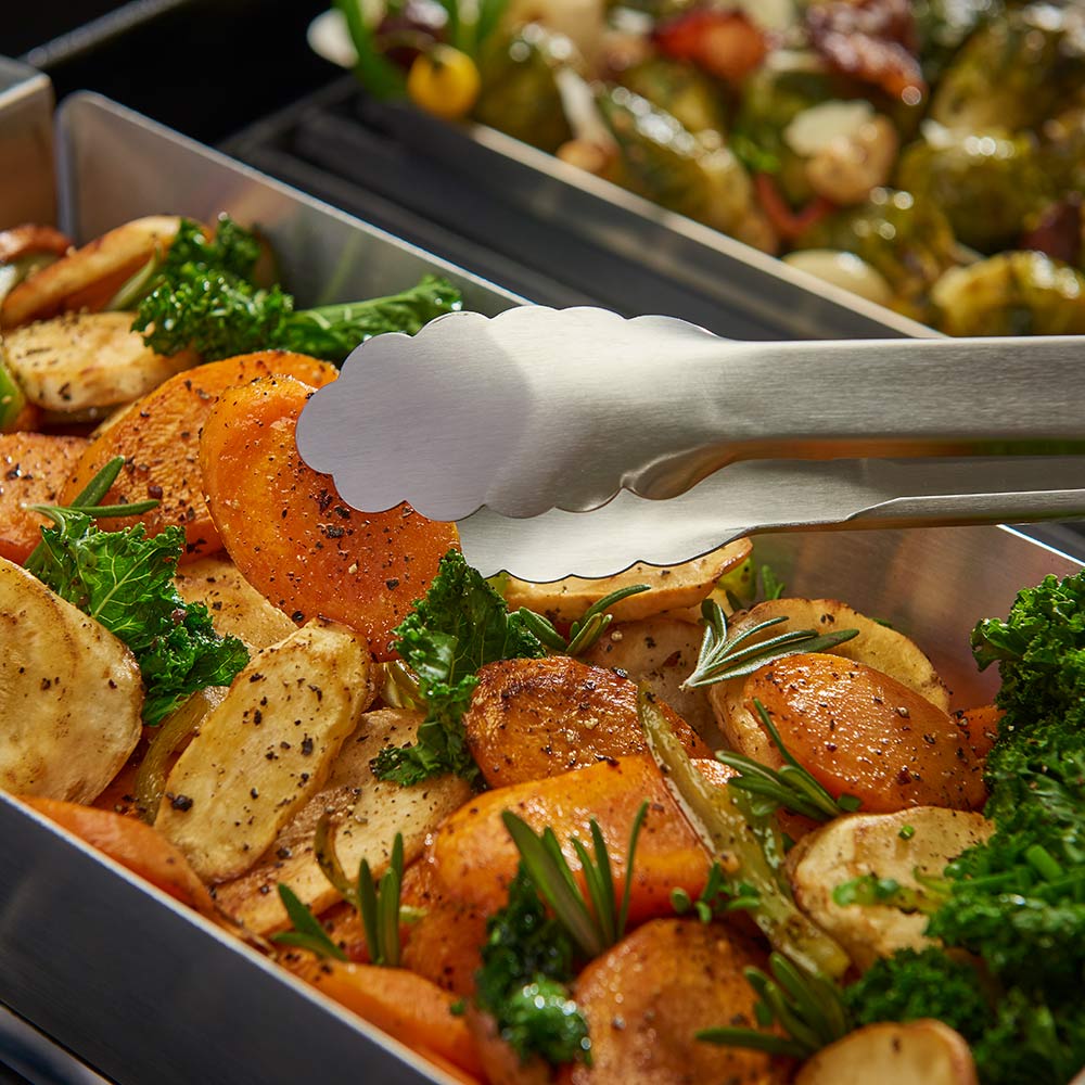 Stainless steel narrow wok topper with roasted chicken and vegetables, served