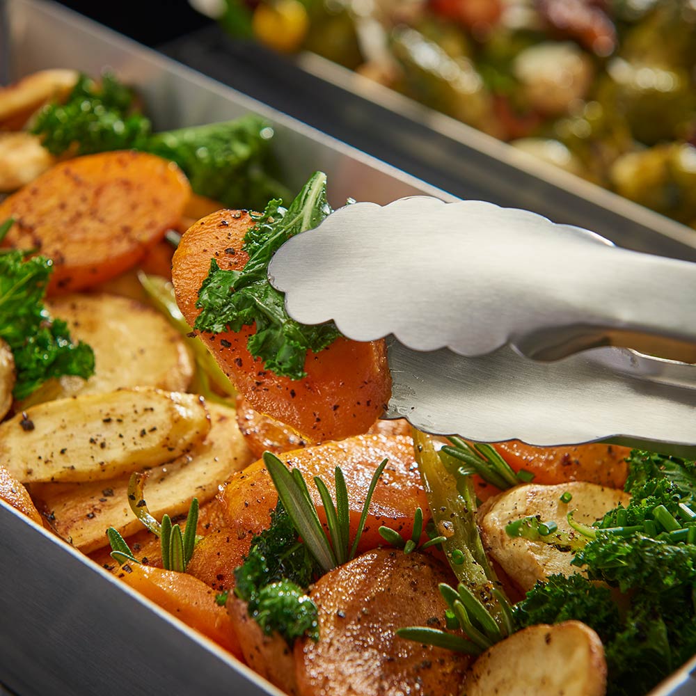 Stainless steel narrow wok topper with sausage, potatoes, and herbs