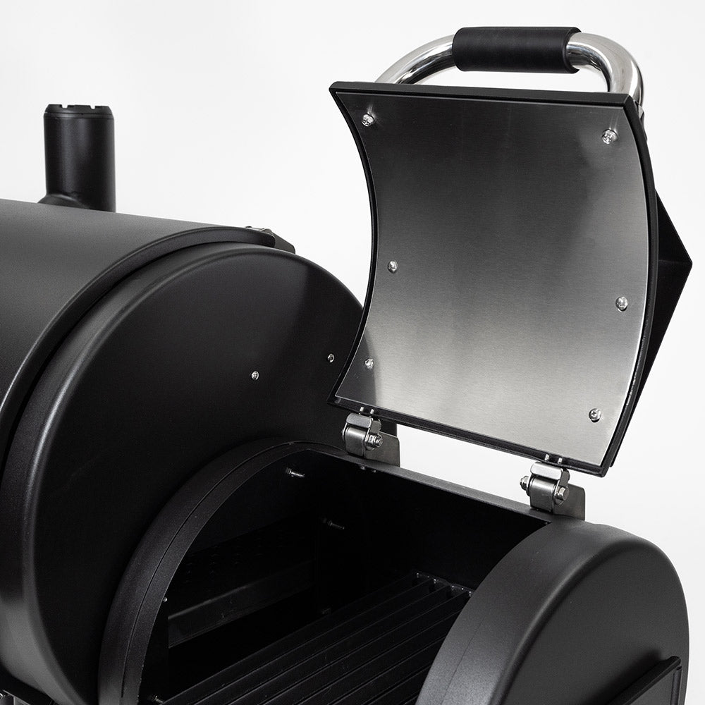 Opened side firebox door with stainless edge and black handle on offset smoker