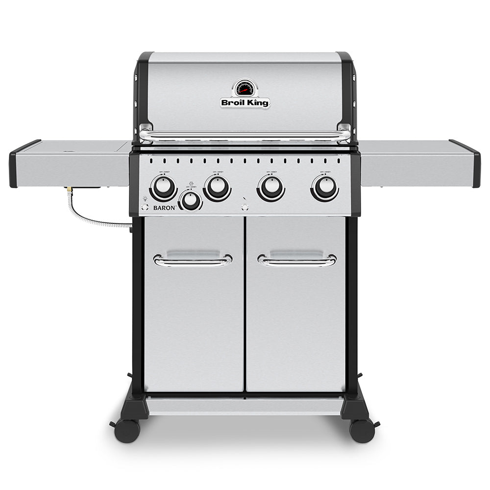 Stainless gas grill with lid closed, front panel and four control knobs