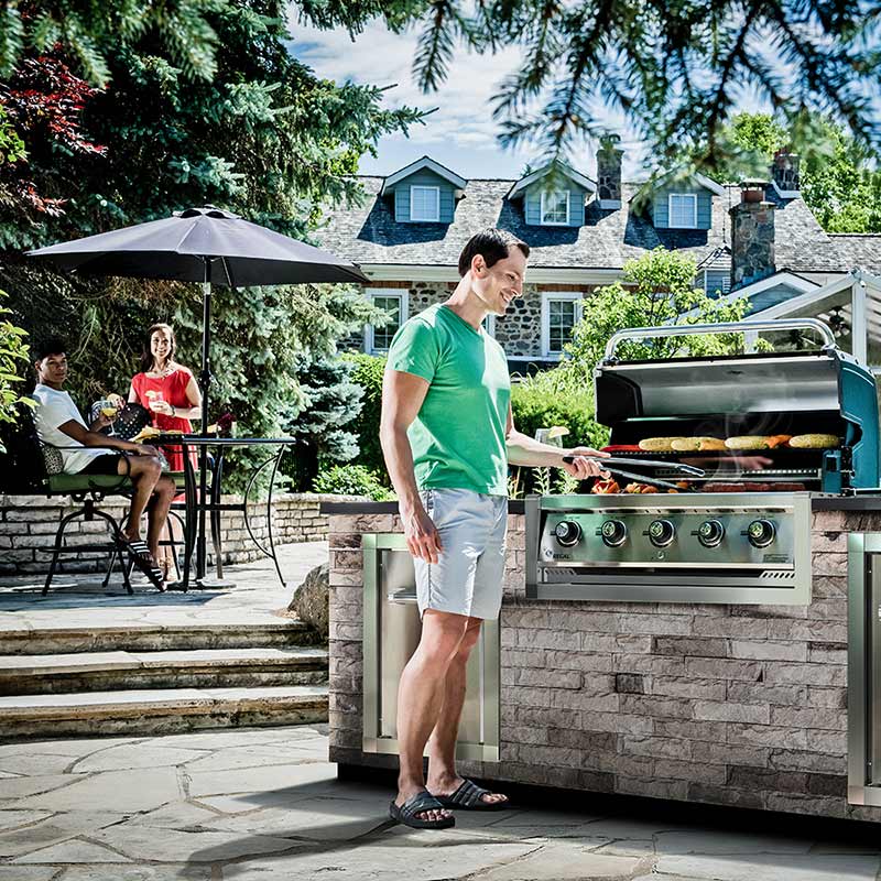 Stainless steel 5-burner built-in gas grill on outdoor patio with open lid