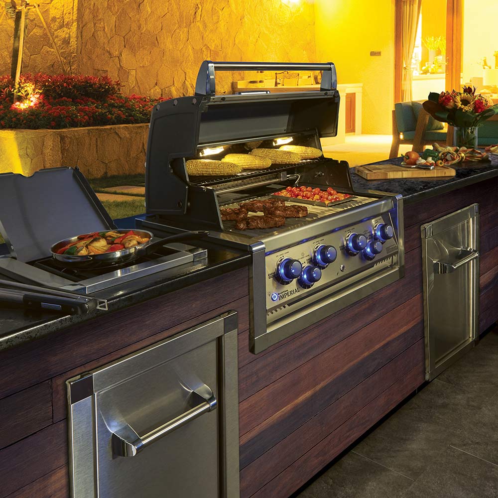 Built-in stainless gas grill with open lid, cooking grates and side burner