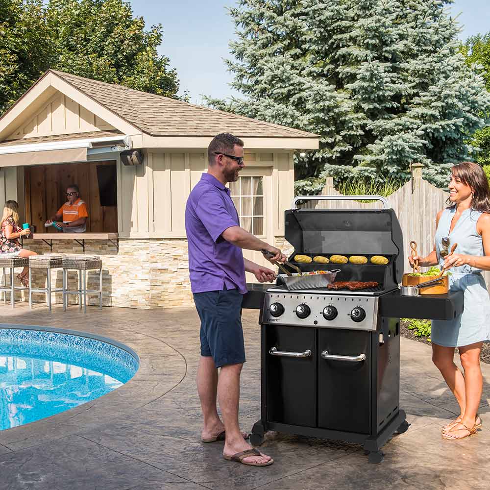 Black 4-burner gas grill with four burners and side shelves, outdoor cooking