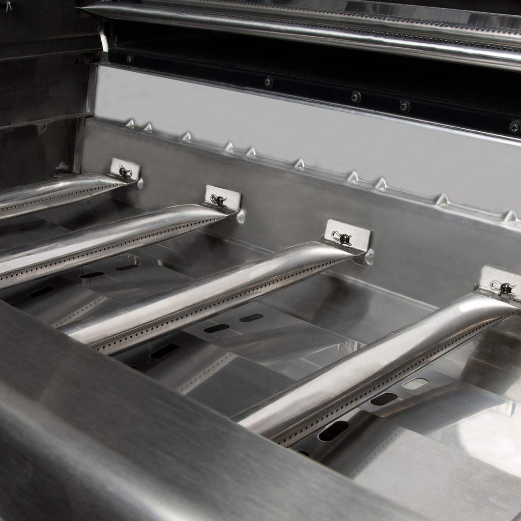 Gas grill firebox with angled burner covers and cooking grates visible