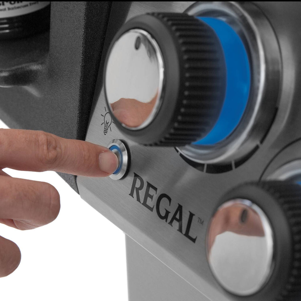 Grill control knob panel with 'REGAL' lettering being adjusted by a finger