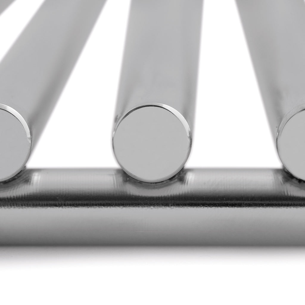 Gas grill burner tubes with circular caps, close-up of stainless steel burner area.