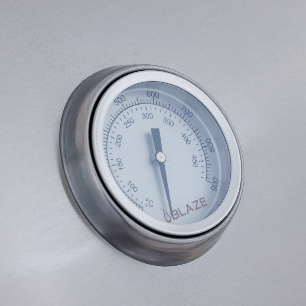 Built-in gas grill thermometer with temperature scale on stainless lid