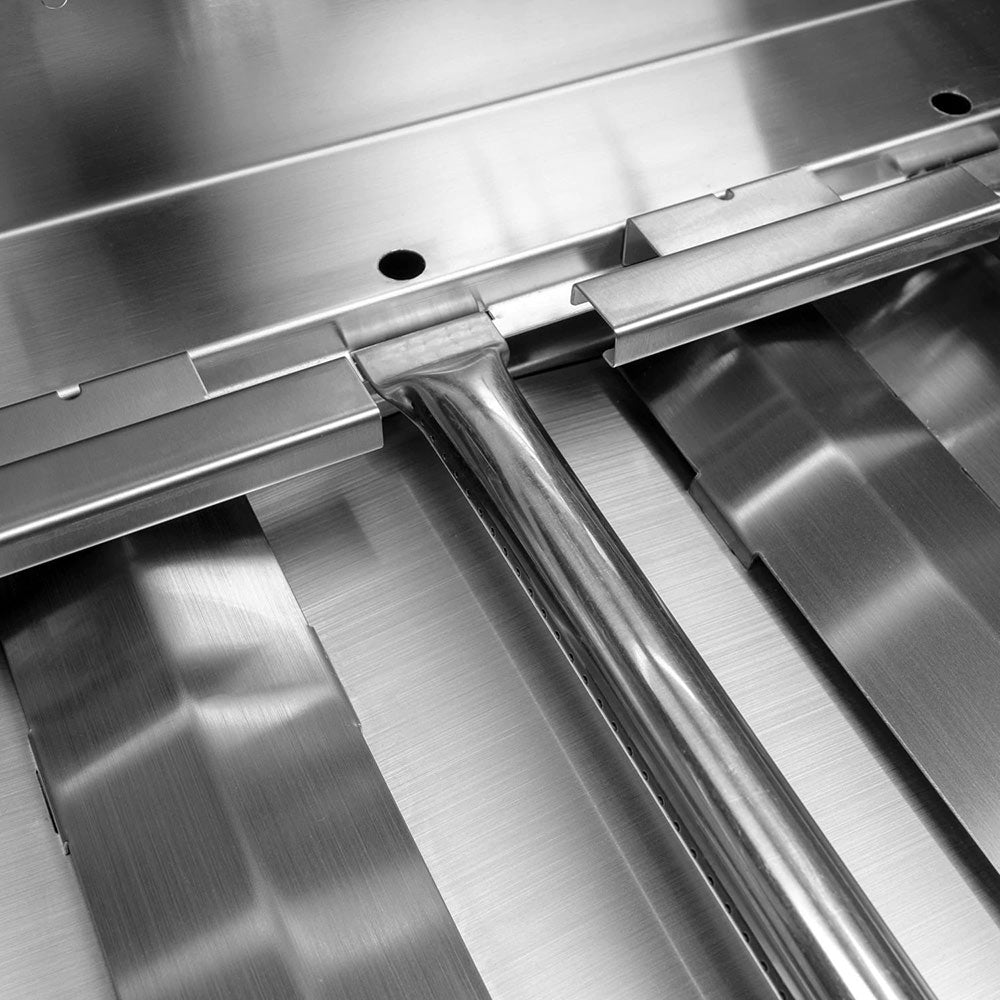 Stainless steel grill burner tubes and heat shield surface inside firebox