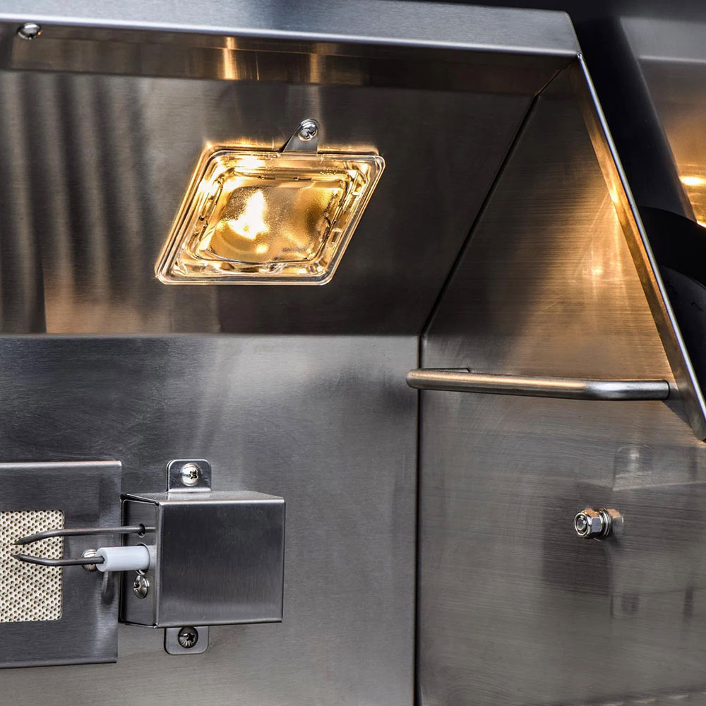 Stainless gas grill with lit interior warming lamp and control knob hardware