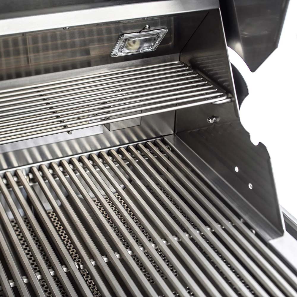 Gas grill grate set with warming rack and interior light above stainless hood