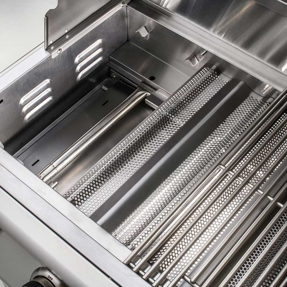 Gas grill open firebox with metal trays and stainless warming rack