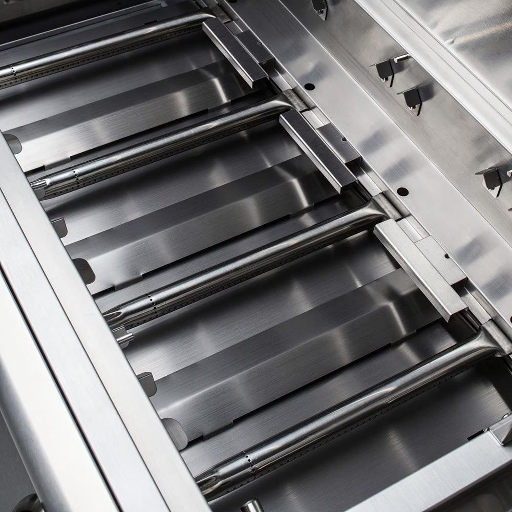 Gas grill open interior with stainless burners and cooking grates