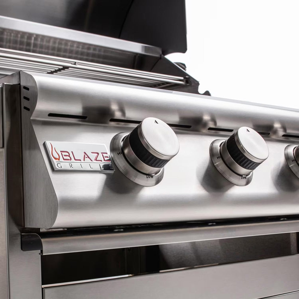 Gas grill front with three burner control knobs and Blaze control panel