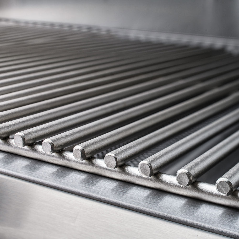 Stainless steel gas grill tube burners with circular igniter caps along the front edge