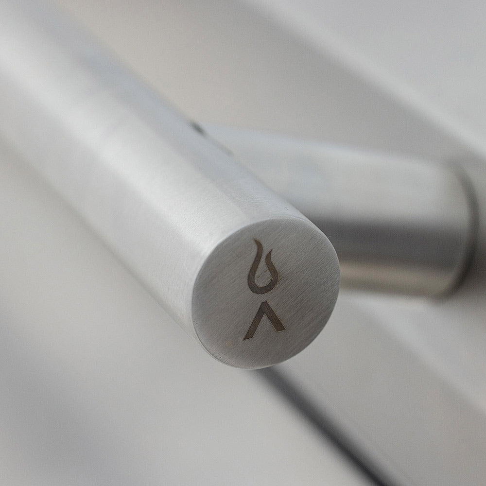 Stainless ignition knob with flame icon on the grill control bar