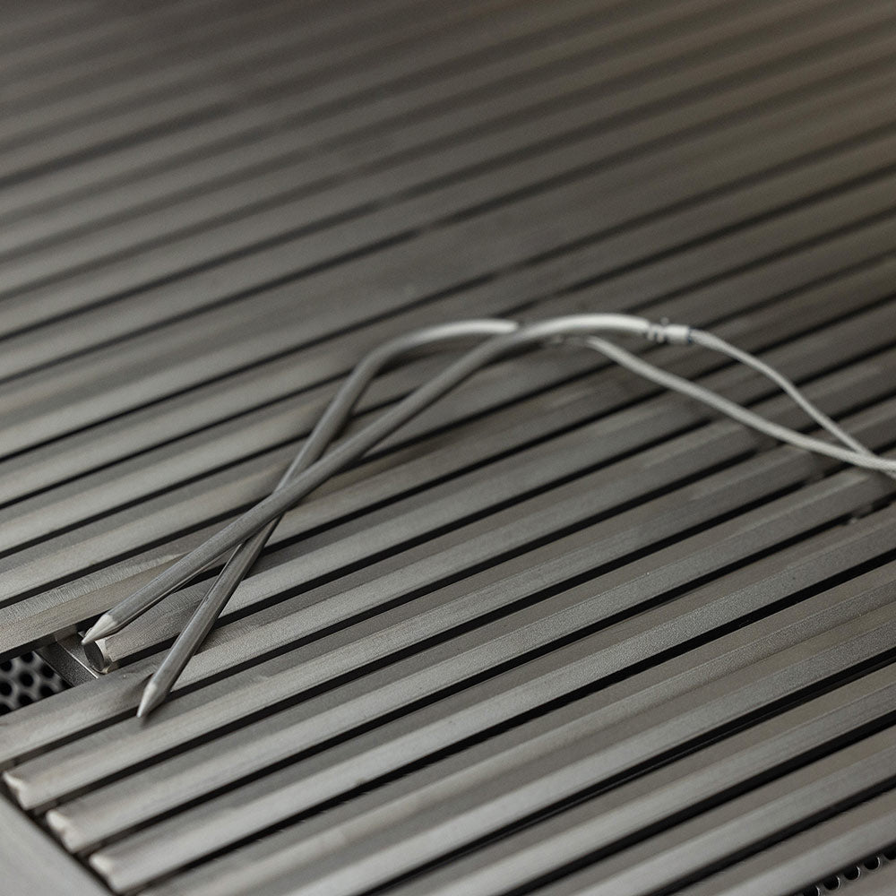 Stainless cooking grates with parallel bars and visible burner tubing