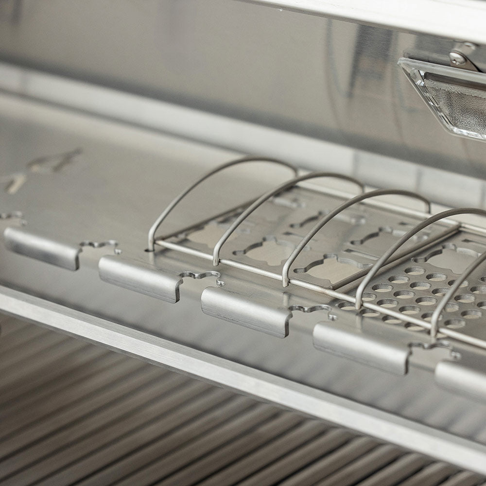 Stainless burner assembly tray with igniter covers and gas tubes along the rail