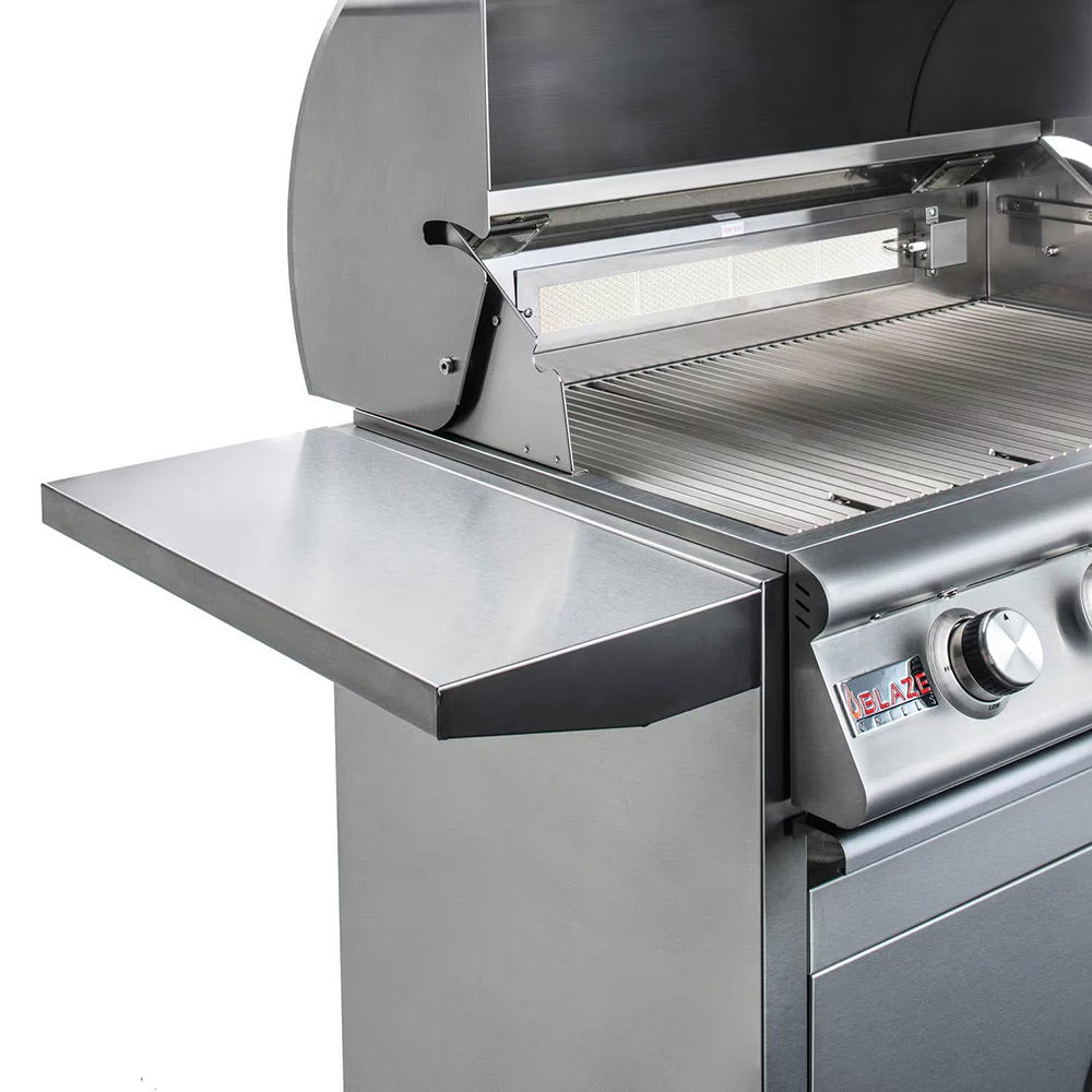 Open stainless steel grill with warming rack and side shelf, knob and valve visible