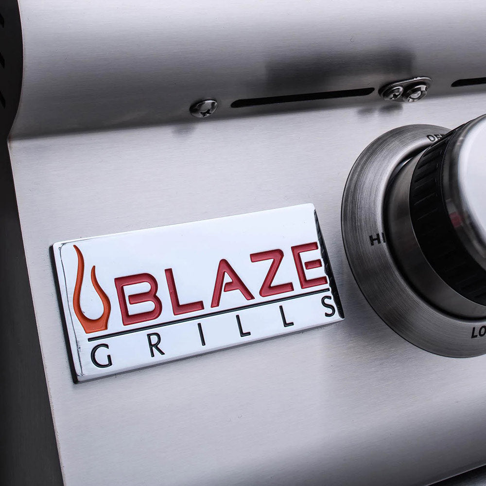 Blaze GRILLS logo badge on stainless grill control panel beside a burner knob