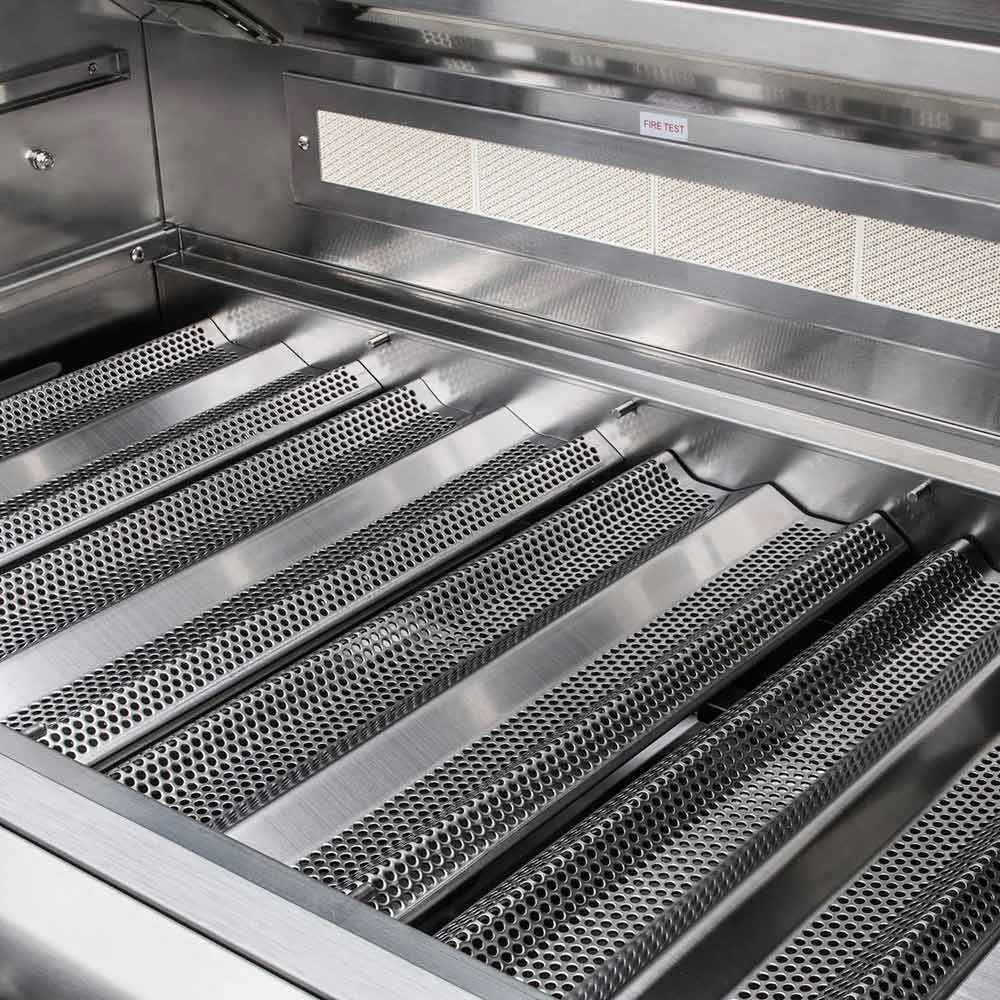 Gas grill cooking area with stainless grates over perforated burner covers