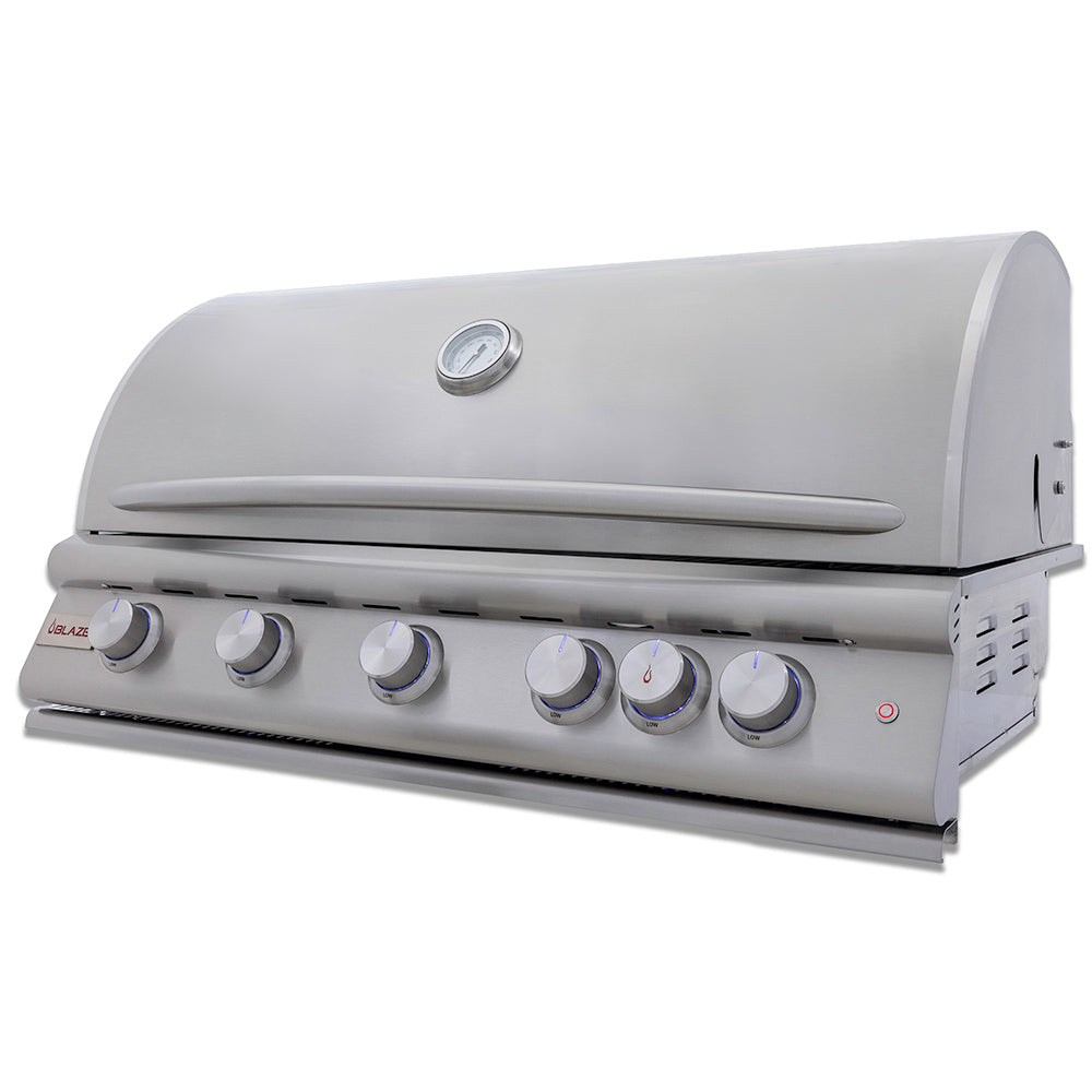 Stainless steel built-in gas grill with control knobs and side control panel