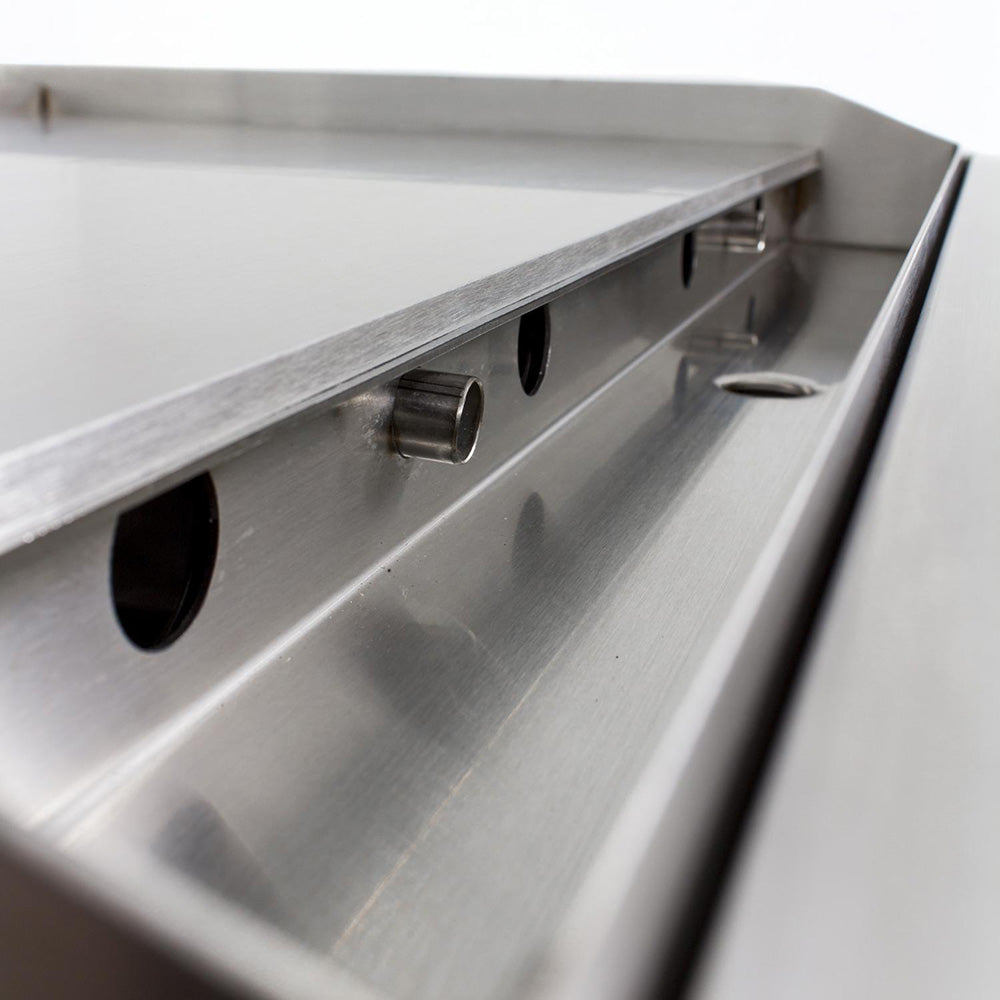 Gas griddle grease tray and side channel with drain openings