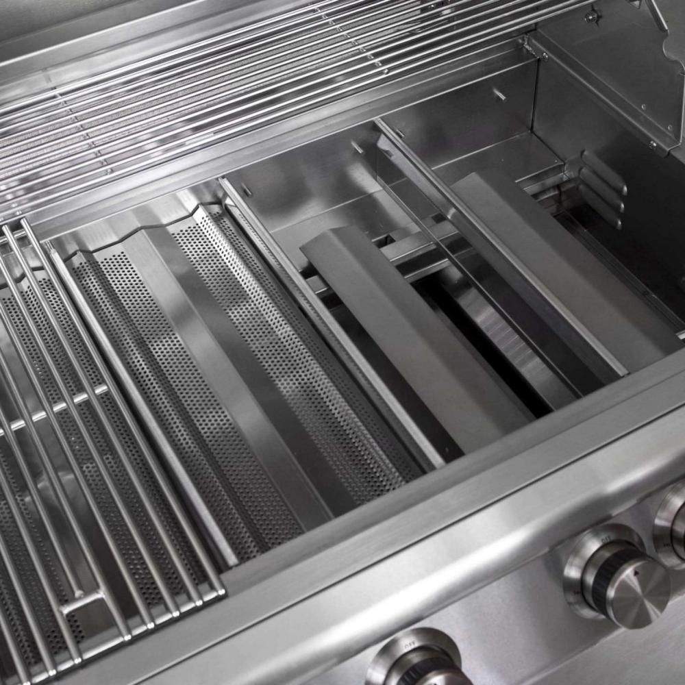Gas grill interior view with metal grates, perforated heat shield, and side controls