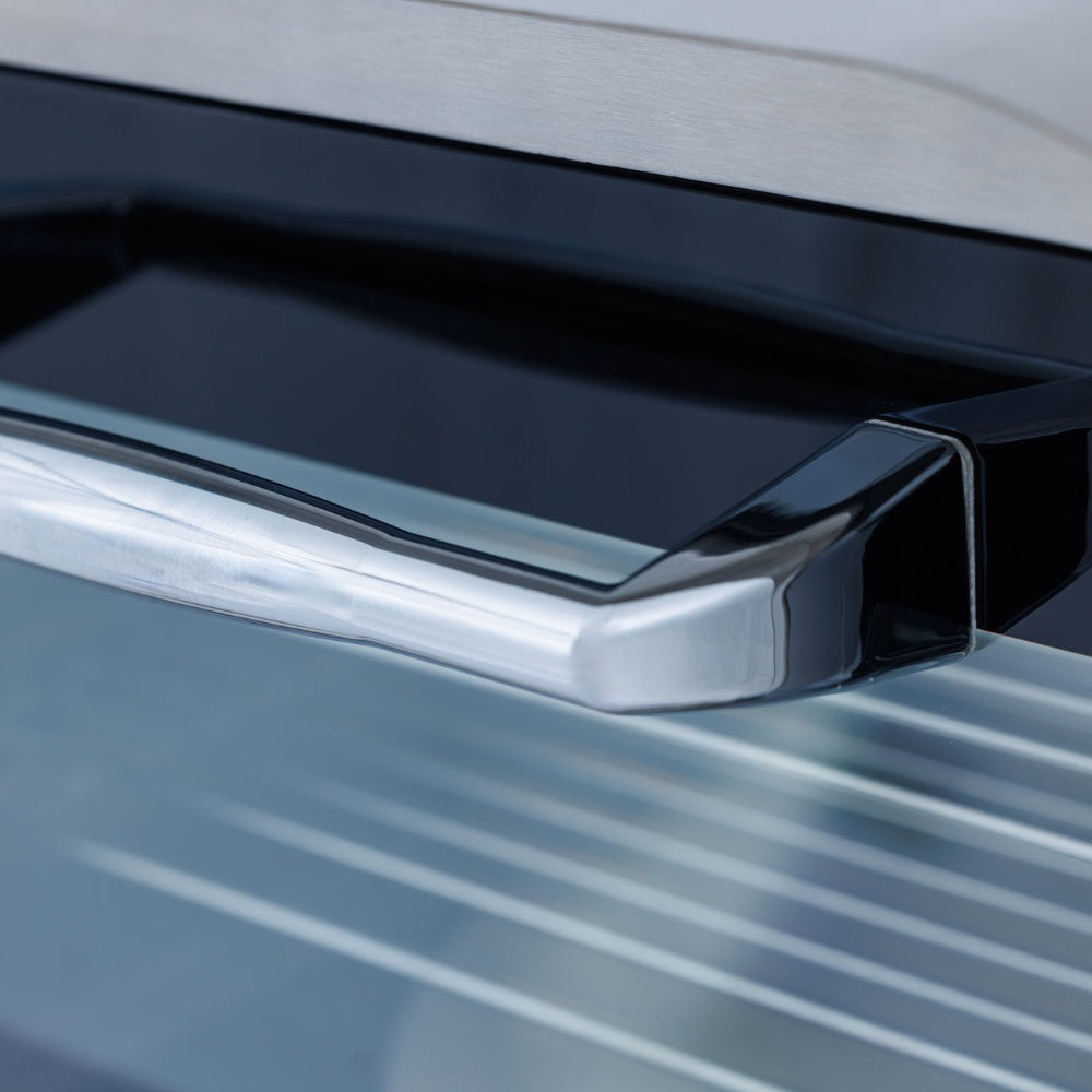 Pizza oven side handle with glossy black trim on stainless steel body