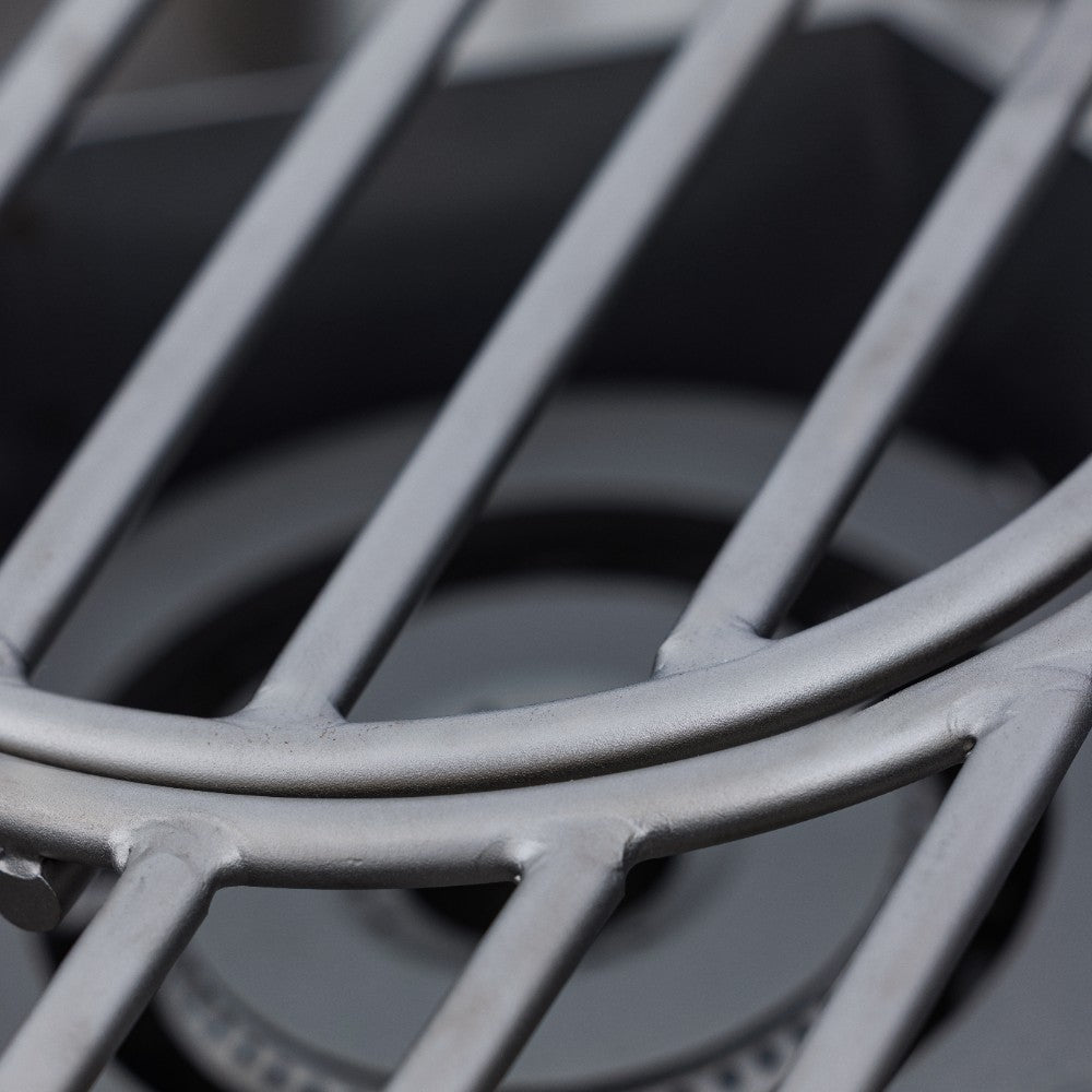 Stainless steel burner grates and curved heat shields