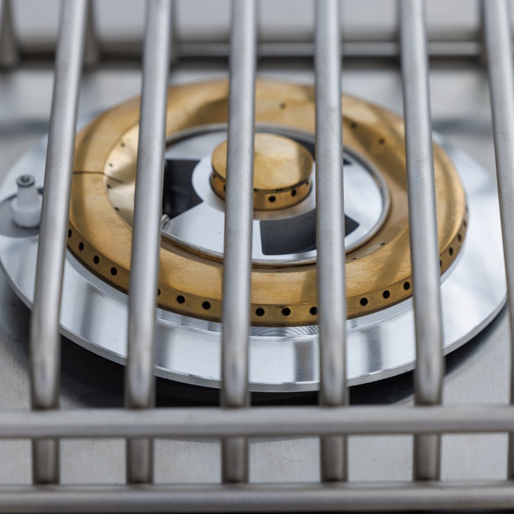 Close-up of single side burner head with brass ring and central burner cap
