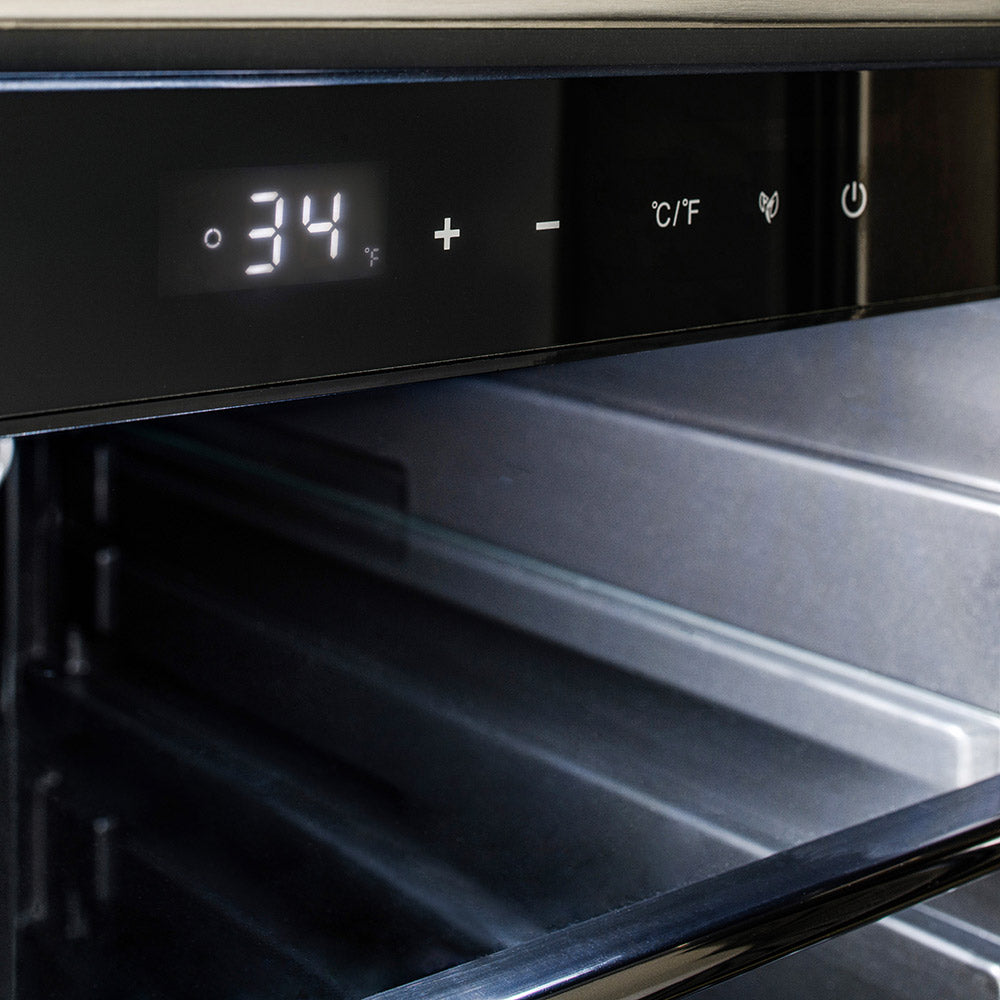 Outdoor stainless refrigerator interior with open shelf and digital temperature display.
