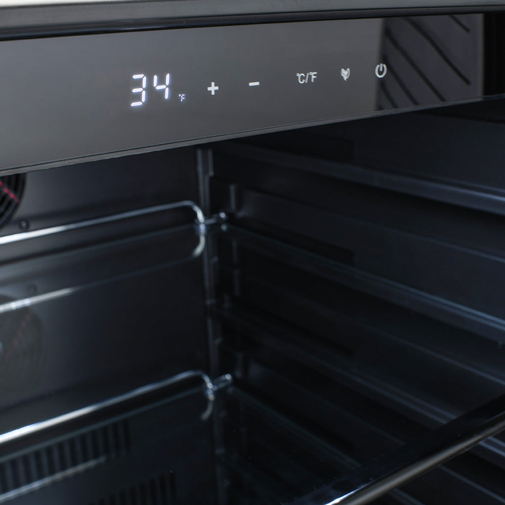 Refrigerator temperature control panel above dark interior shelves