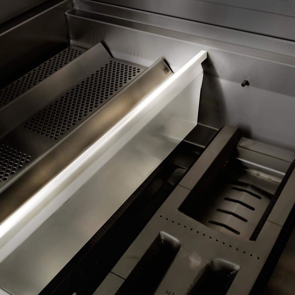 Stainless steel grill interior showing rear vent and warming or heat area