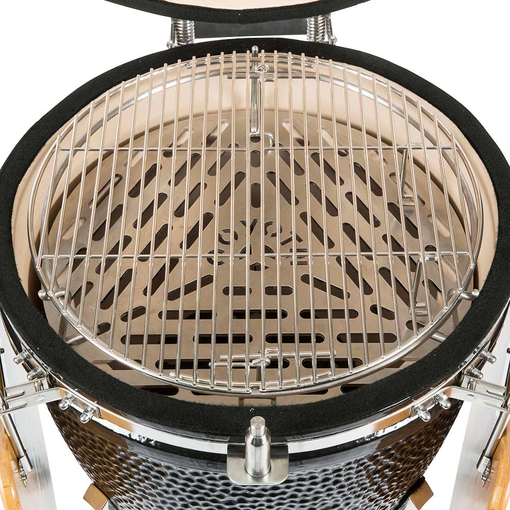 Ceramic smoker interior with wire cooking rack and open domed lid