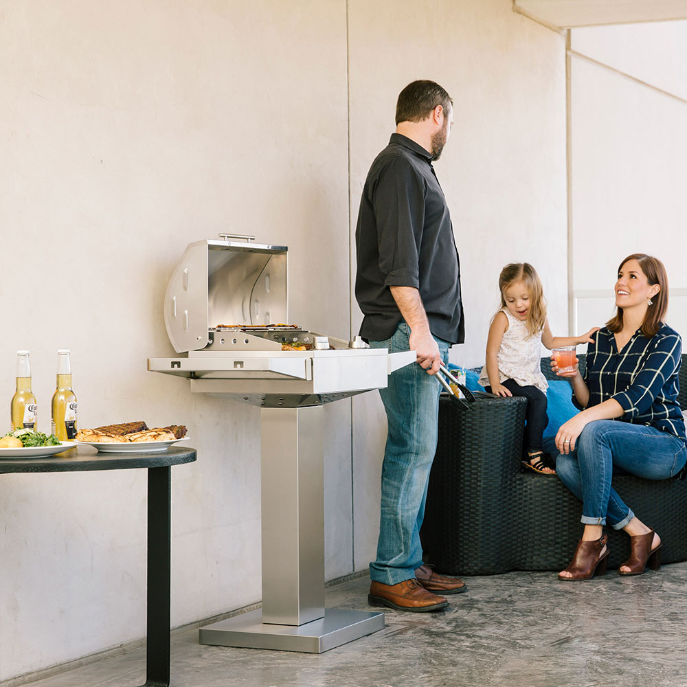 Stainless steel electric grill pedestal with open hood and burners visible