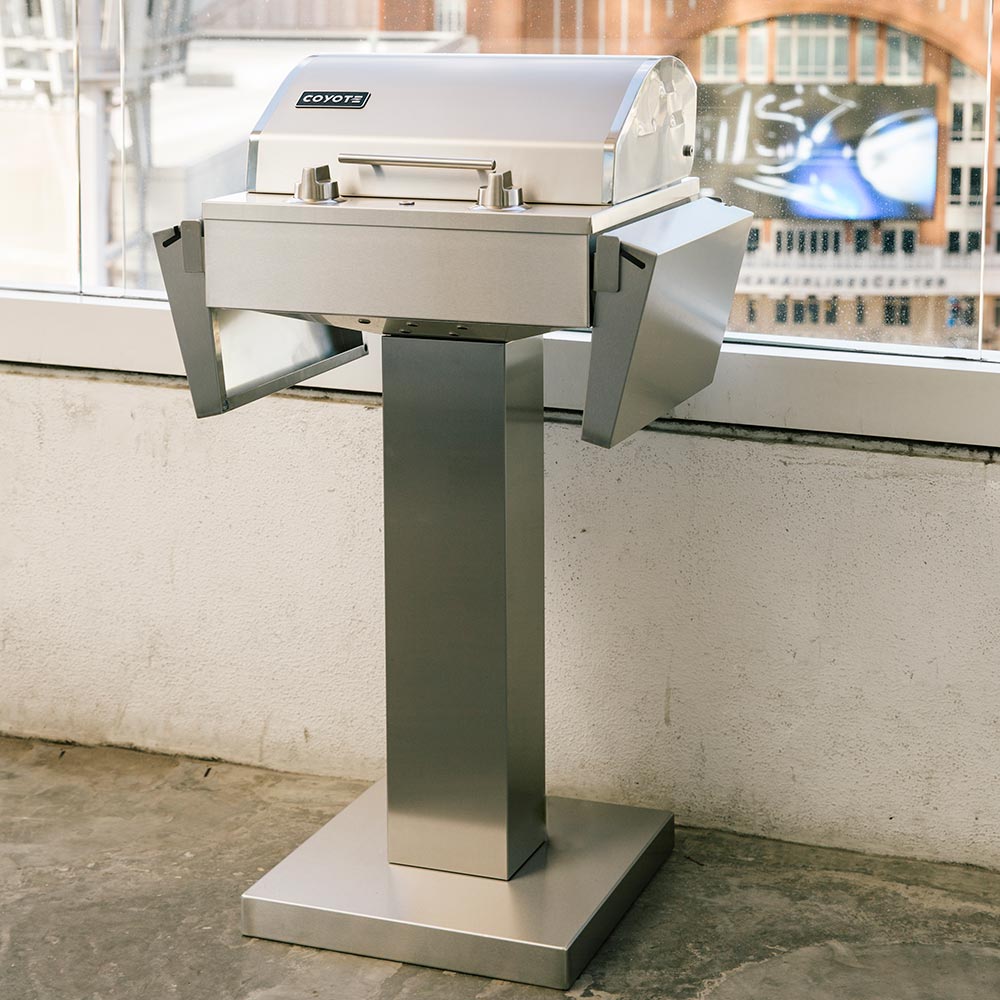 Stainless steel electric grill pedestal in front view with lid closed