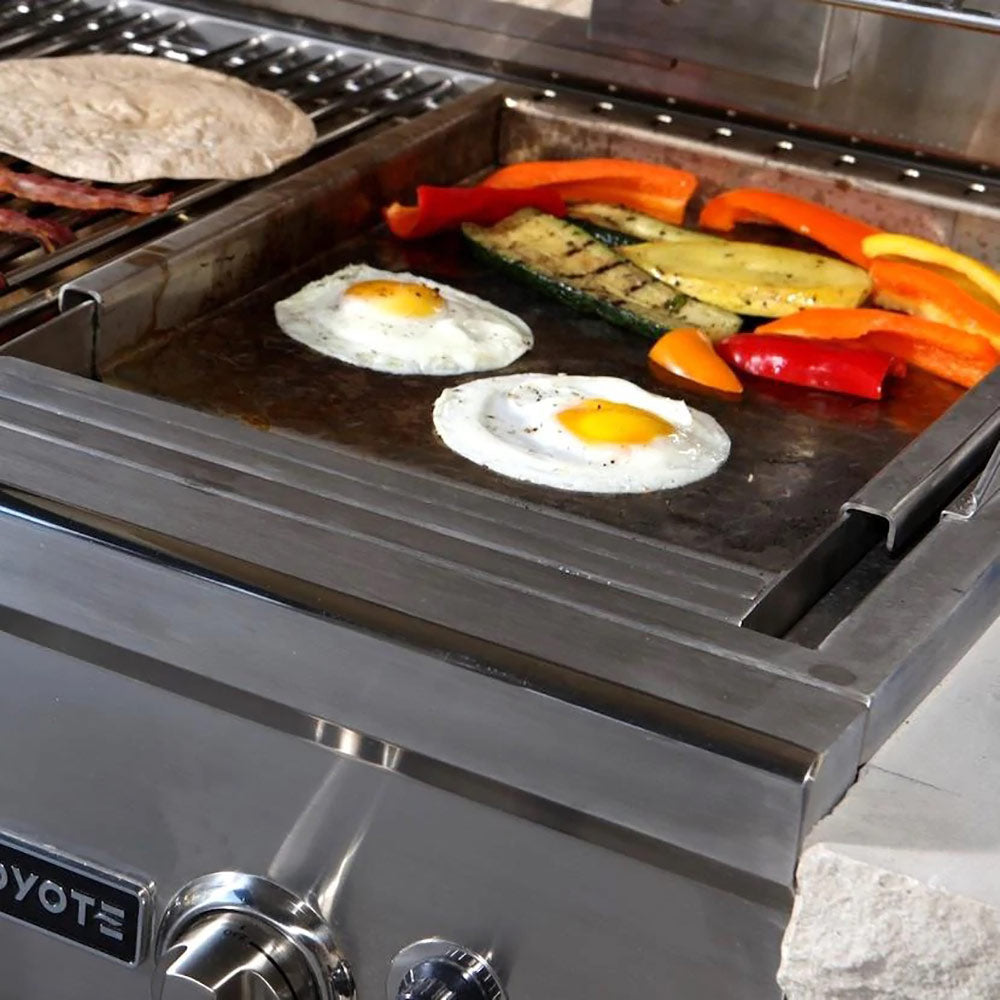 Stainless steel drop-in griddle with sunny-side eggs and sliced peppers on flat surface
