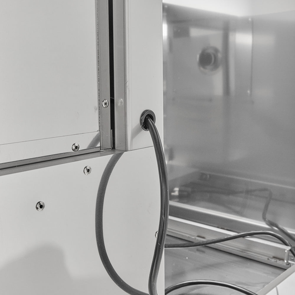 Warming drawer interior with installed cable and metal rack base