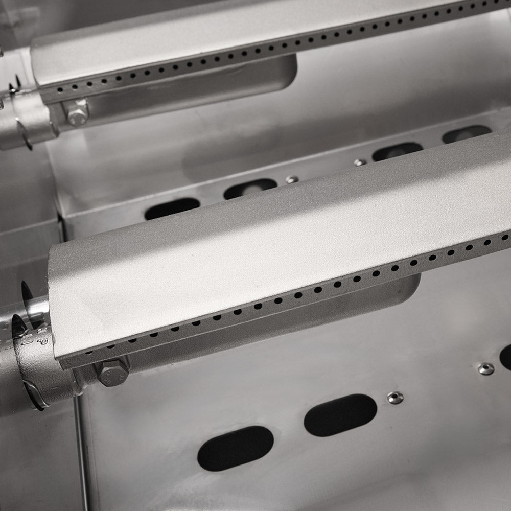 Stainless steel gas grill burner area with vent holes and underside shelf