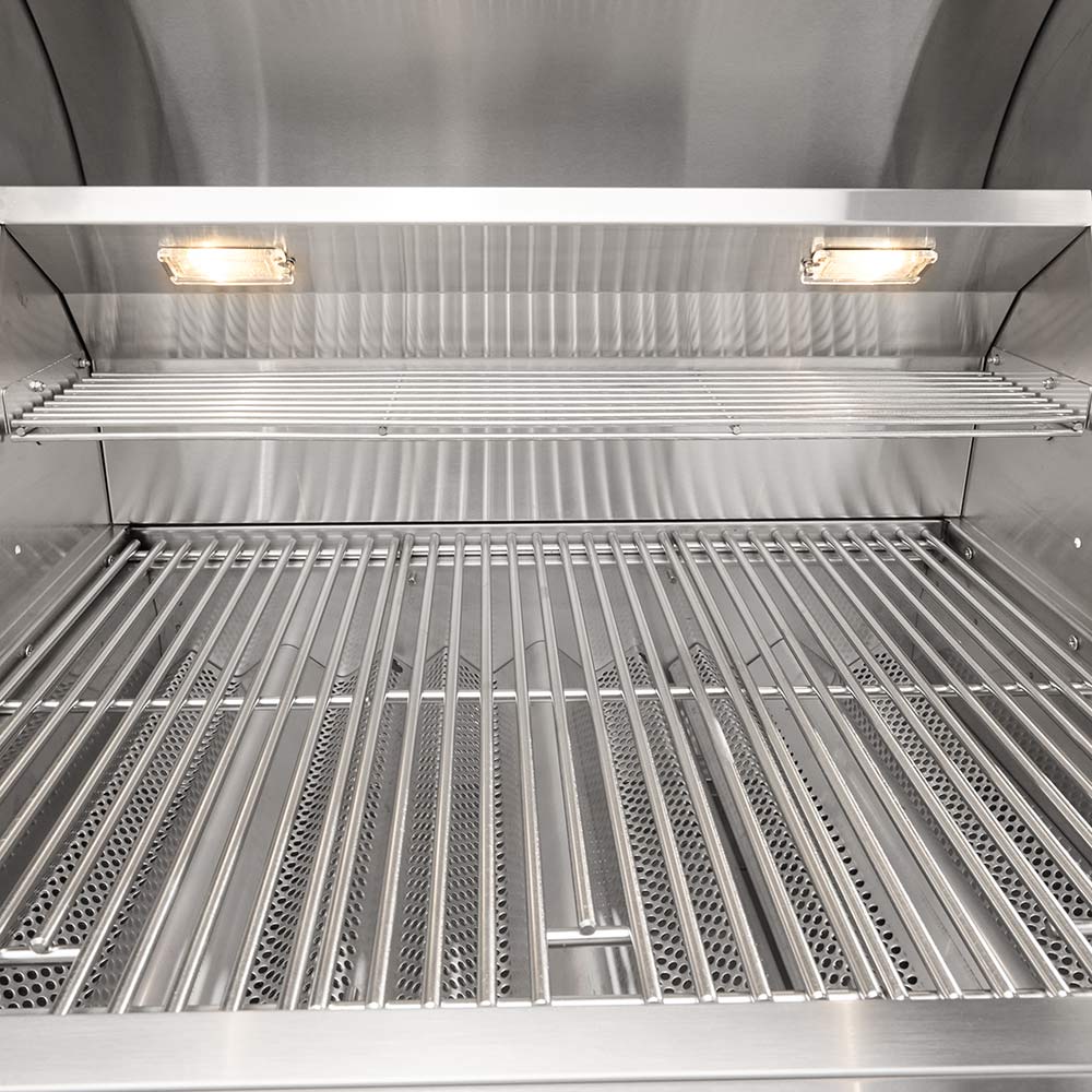 Stainless steel gas grill interior with rod-style grates and warming lights