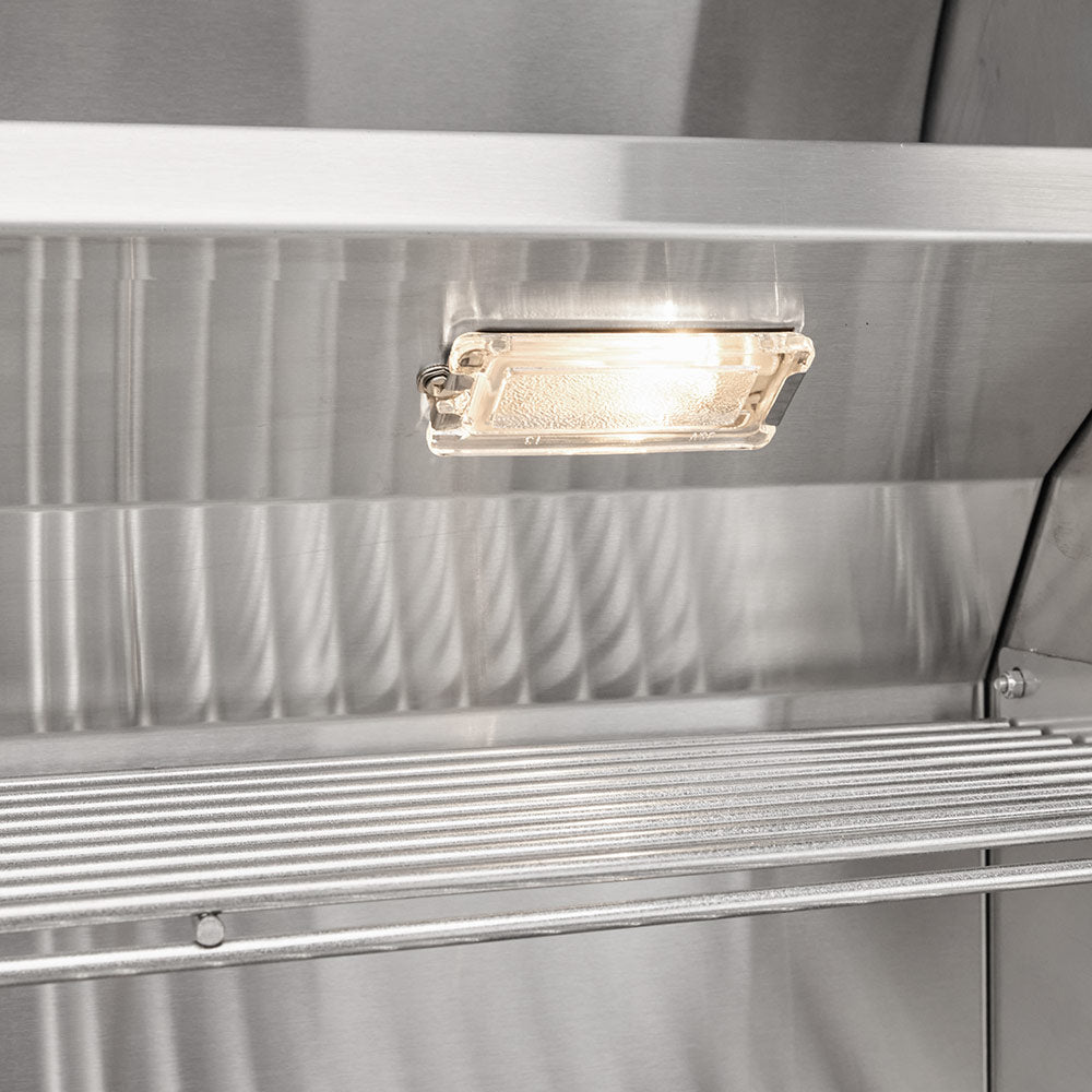 Built-in gas grill with interior light fixture under the stainless steel hood
