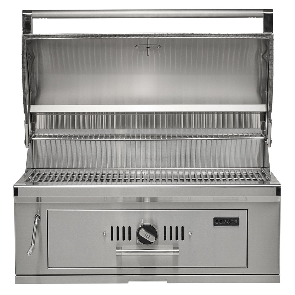 Open stainless steel charcoal grill with cooking grates and warming rack