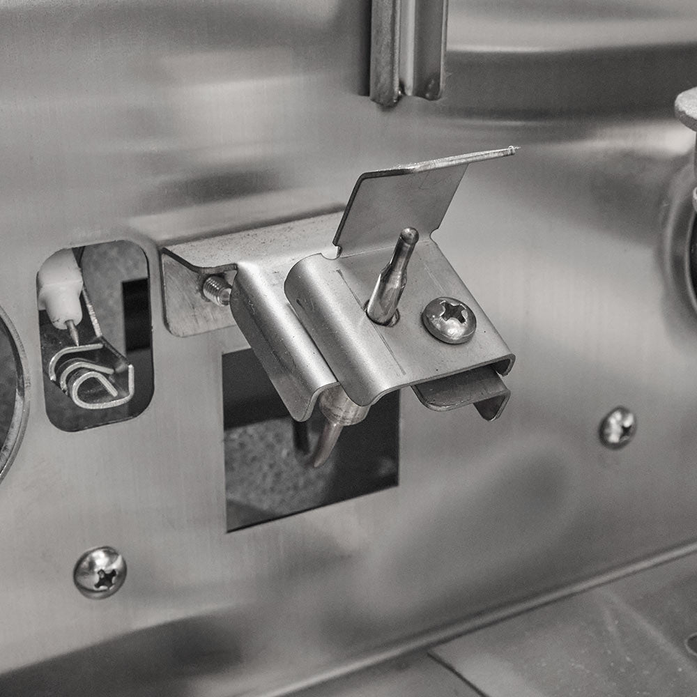 Stainless steel burner and igniter controls on side panel inside gas grill