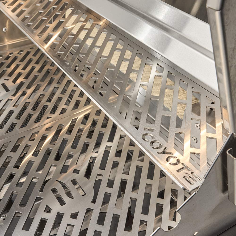 Stainless steel cooking grate with angled heat plates inside built-in grill