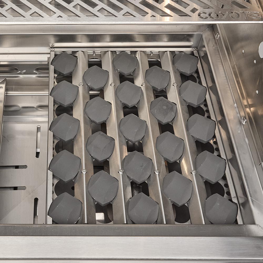 Stainless steel grill with multiple capped burners inside the firebox