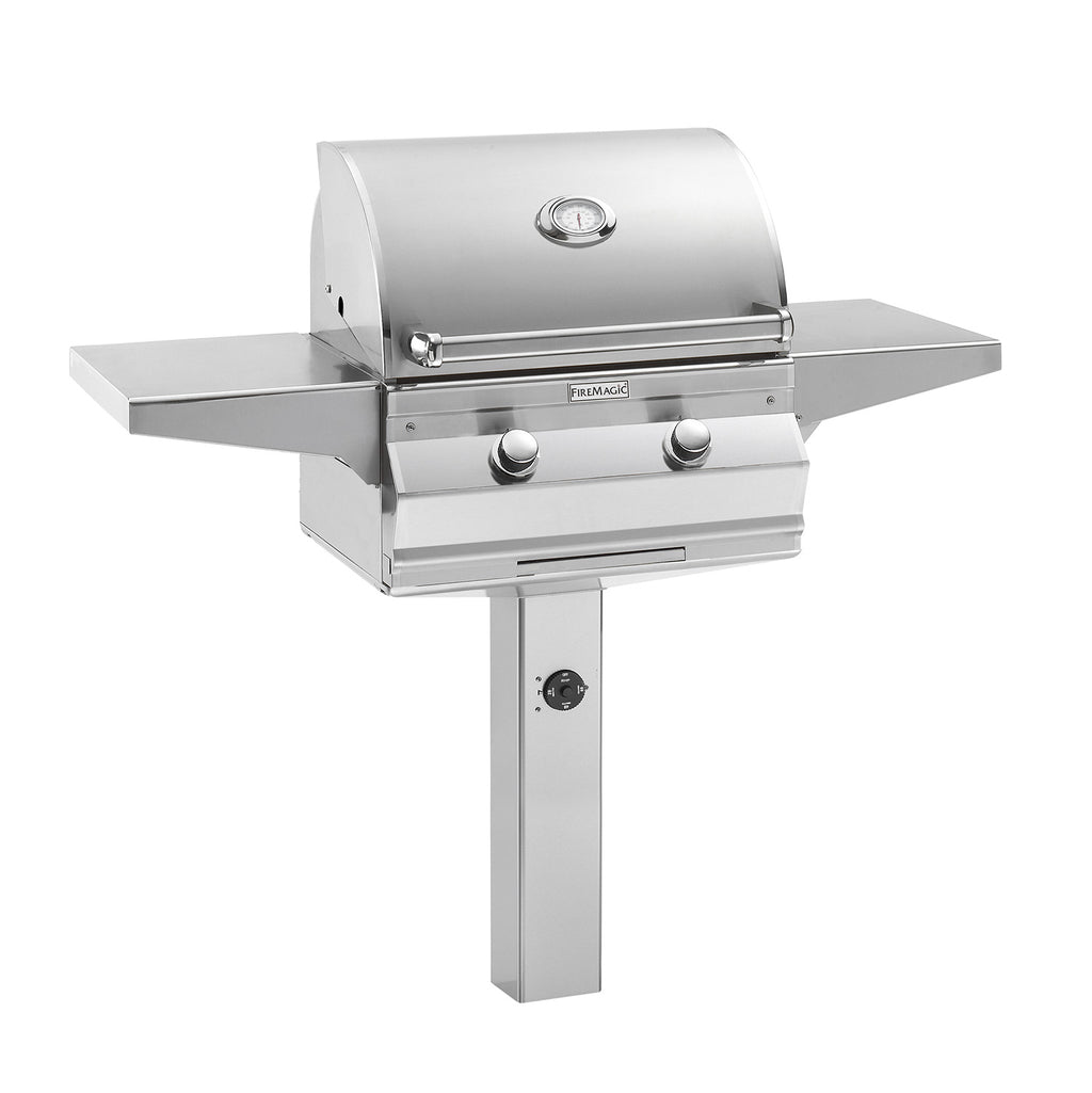 Stainless gas grill with lid, two control knobs, and side shelves on post mount