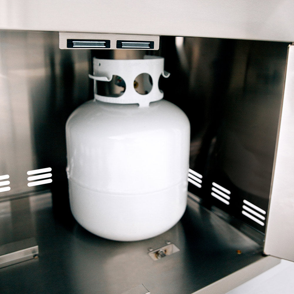 White propane gas cylinder stored in lower grill cabinet
