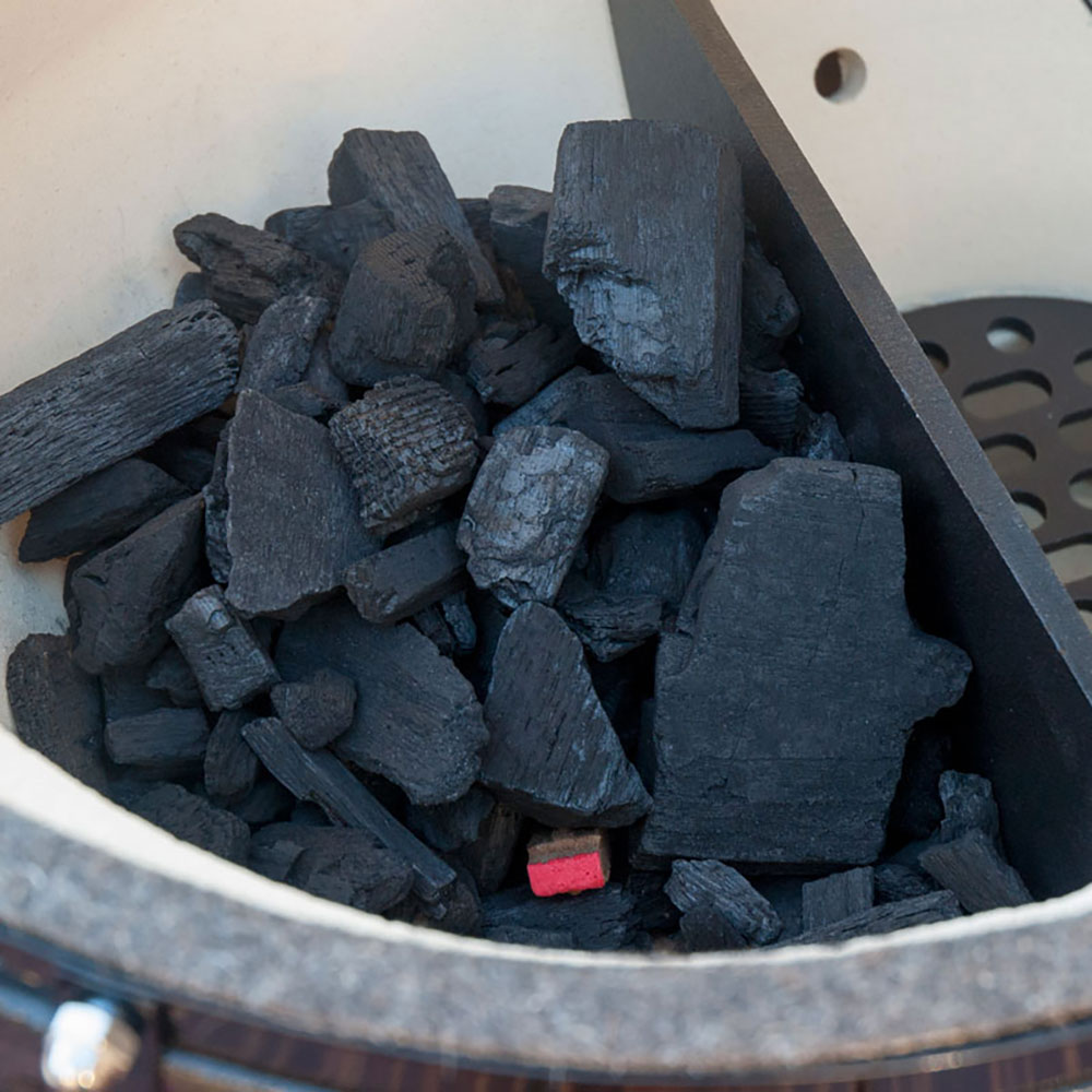 Firestarter pieces in metal grill basket, dark charcoal-colored blocks