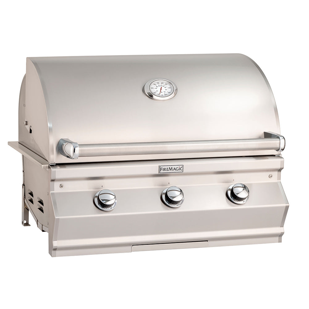 Stainless built-in gas grill with hood and three control knobs, side shelves.